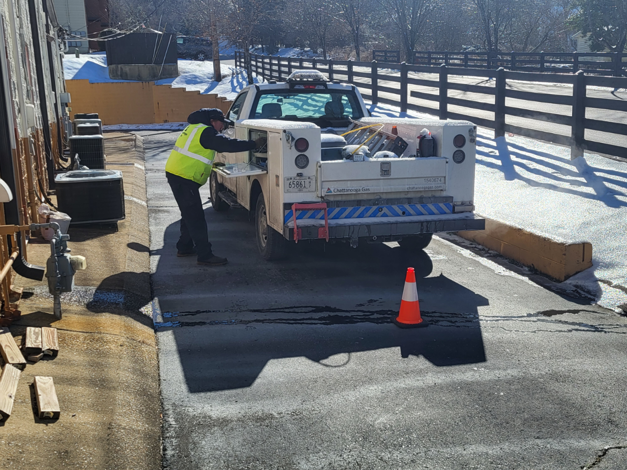 man grapping something out of service truck