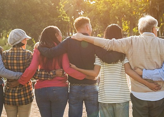 group of people with arms wrapped around each other 